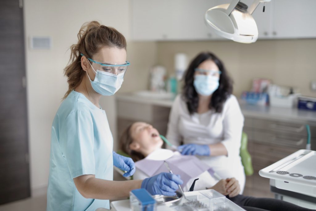 Two dentists examining a patient.